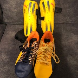 Puma soccer cleats and shin guards